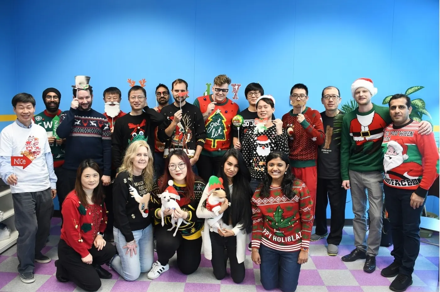 The Inchol team at the year-end party in holiday sweaters